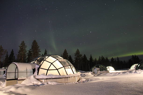 behold the northern lights from glass igloo in finland